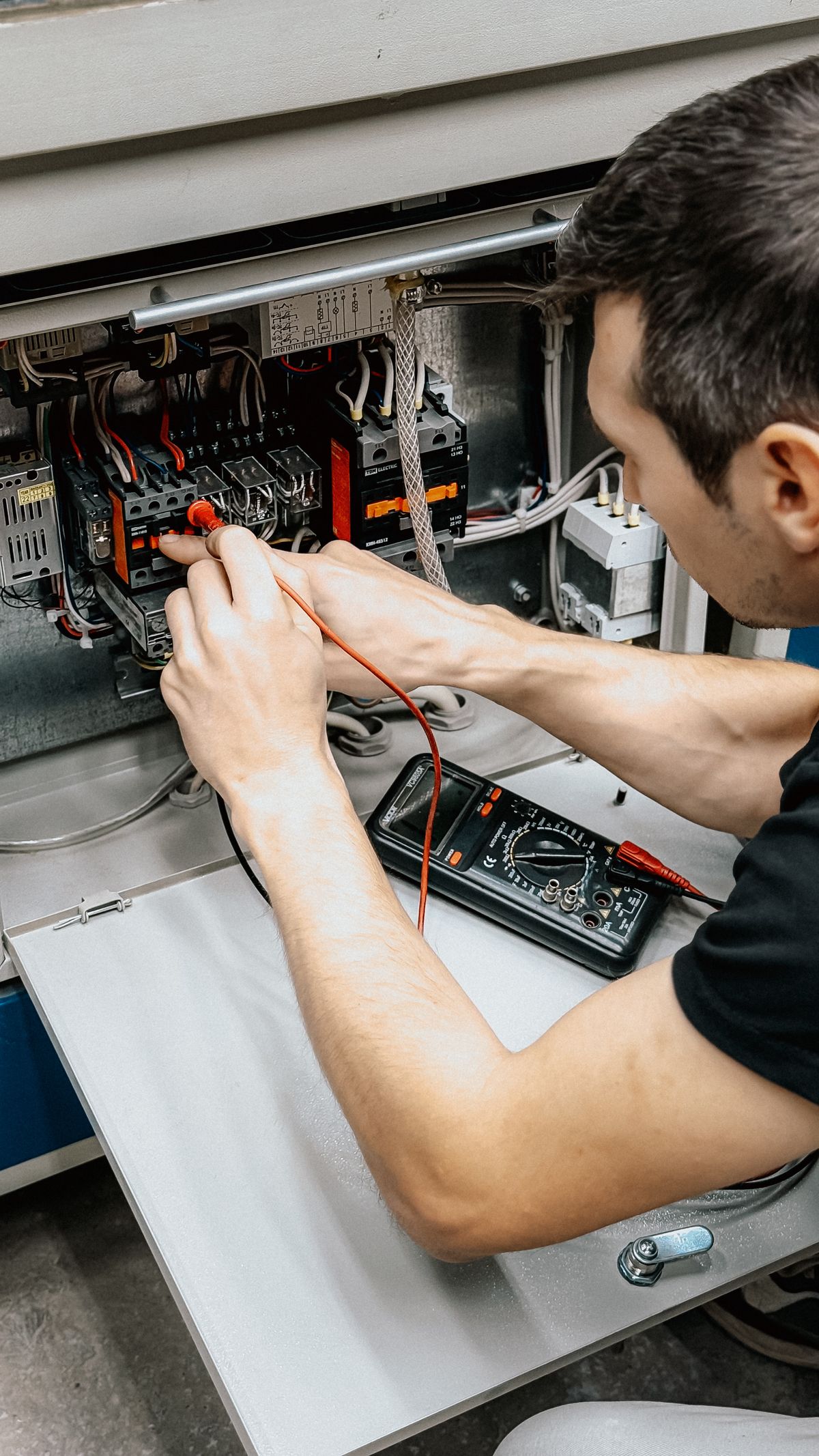 Licensed electrician working on a residential electrical panel in Virginia Beach, VA